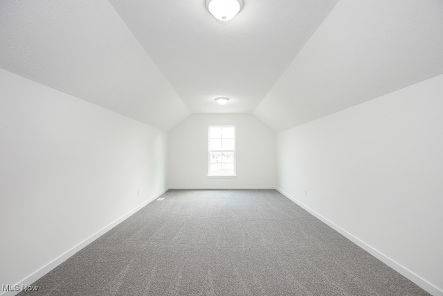 bonus room with carpet and lofted ceiling