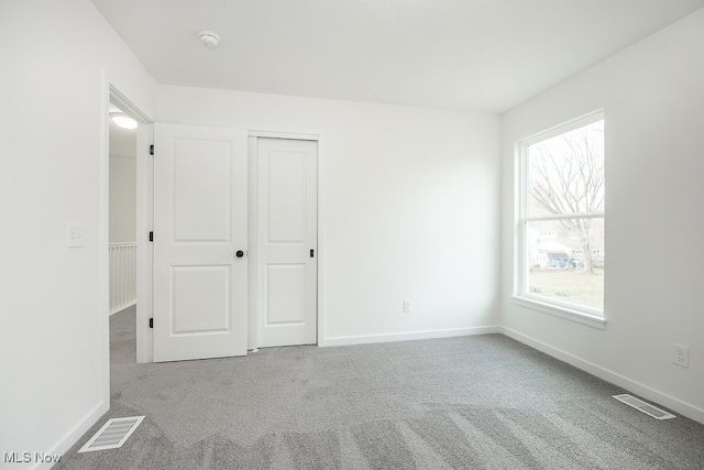 unfurnished bedroom featuring carpet and a closet