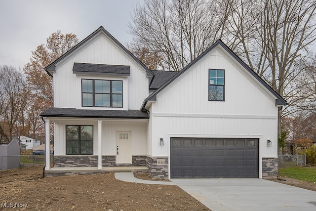 modern inspired farmhouse with a garage