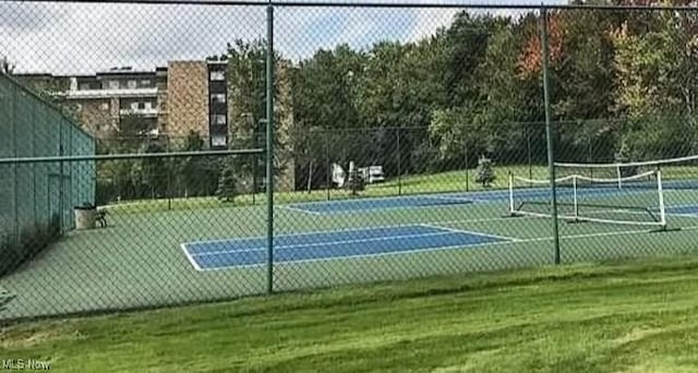 view of sport court featuring a yard