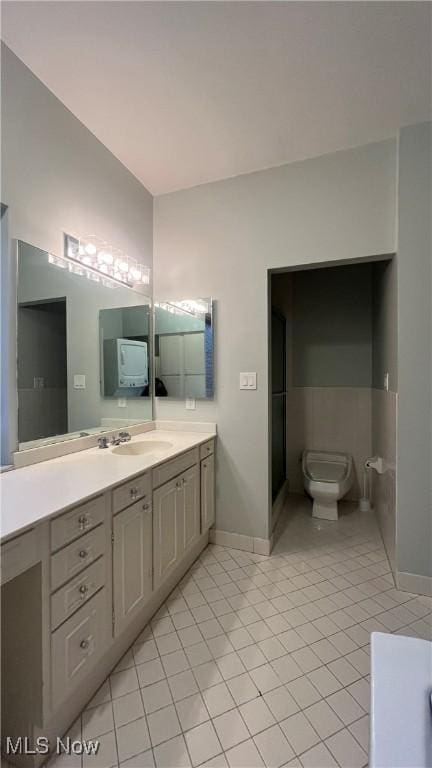 bathroom featuring tile patterned flooring, vanity, and toilet