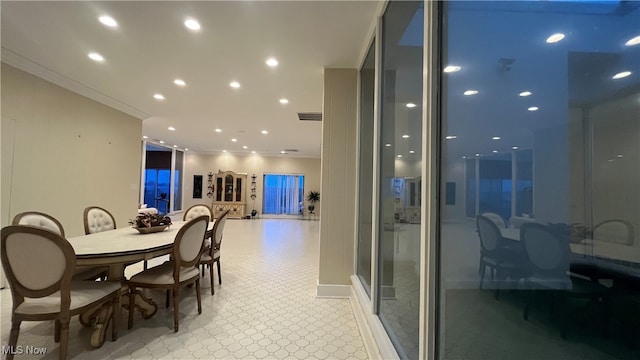 dining space with ornamental molding