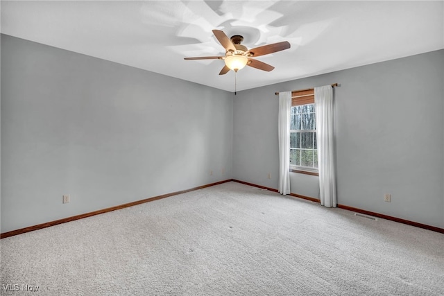 unfurnished room with light colored carpet and ceiling fan