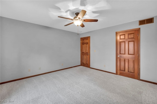 spare room featuring carpet flooring and ceiling fan