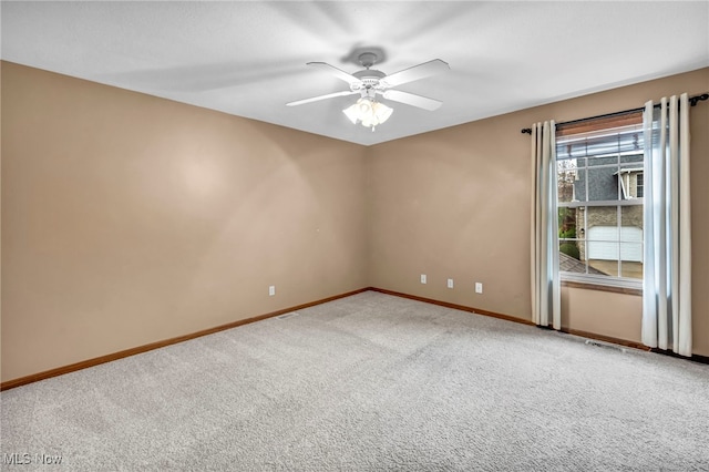 carpeted spare room featuring ceiling fan