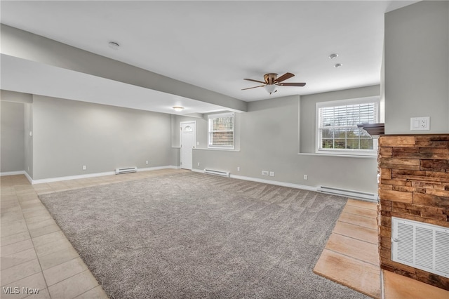 unfurnished living room with ceiling fan, light tile patterned floors, and baseboard heating