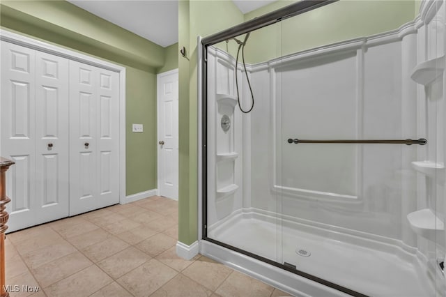 bathroom with tile patterned floors and an enclosed shower