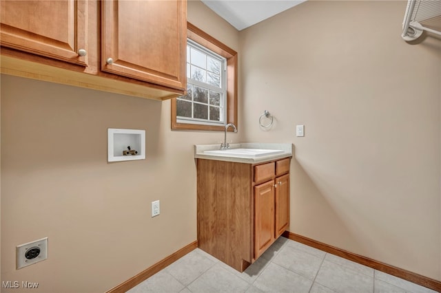 laundry room with hookup for an electric dryer, hookup for a washing machine, cabinets, sink, and light tile patterned floors