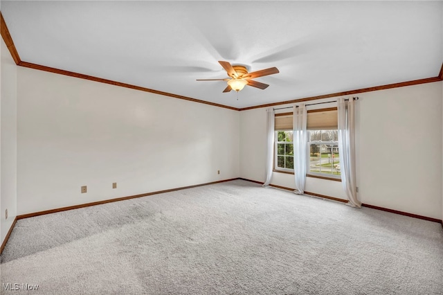 empty room with light colored carpet, ceiling fan, and crown molding