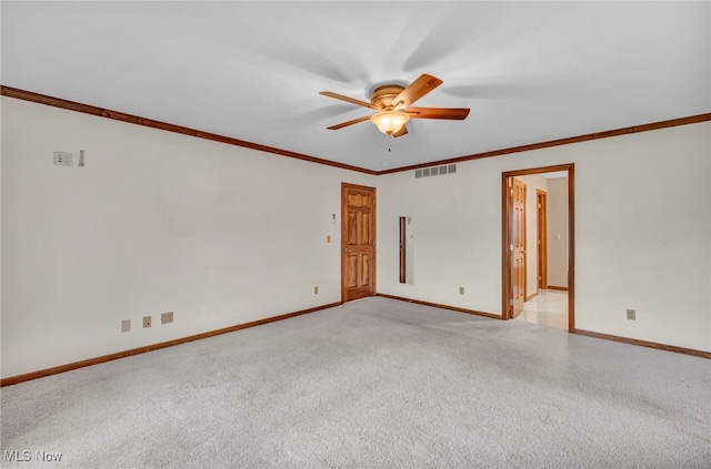 empty room with ceiling fan, light colored carpet, and ornamental molding