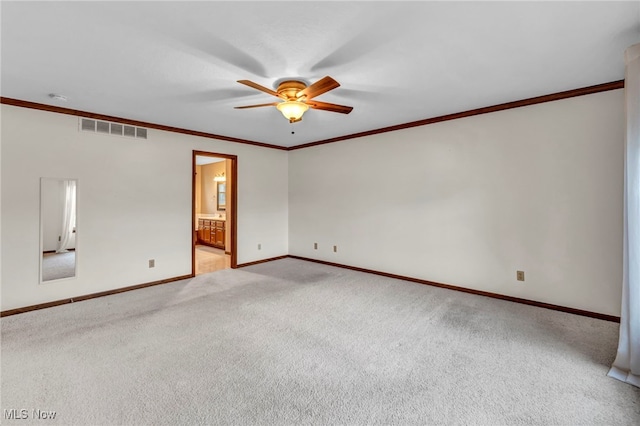 spare room featuring visible vents, light colored carpet, ceiling fan, and ornamental molding