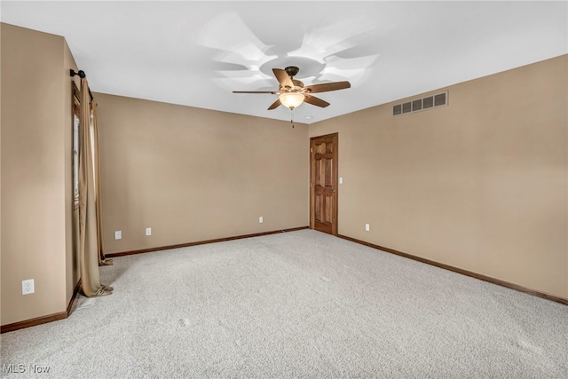 carpeted spare room with ceiling fan