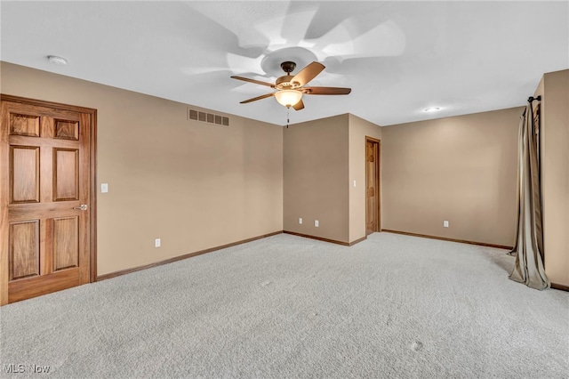 unfurnished room with ceiling fan and light colored carpet