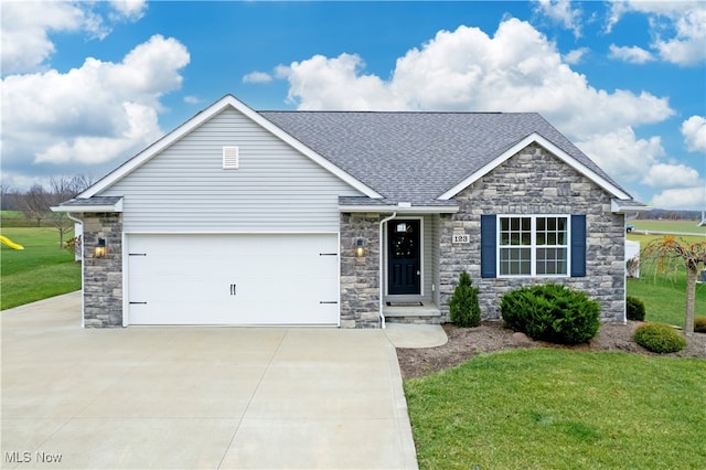 view of front of house featuring a garage and a front yard