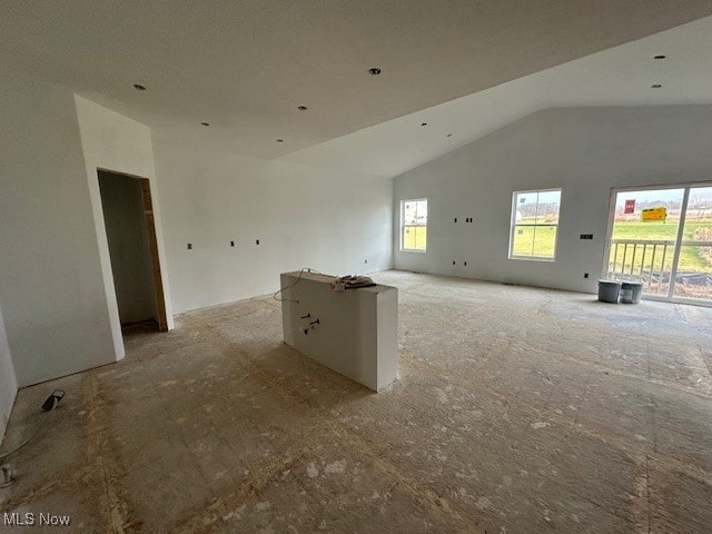 unfurnished living room with vaulted ceiling