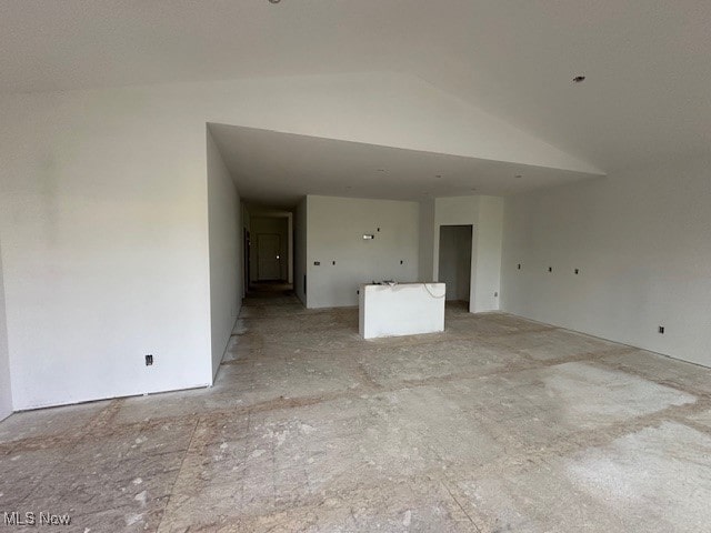 empty room featuring lofted ceiling