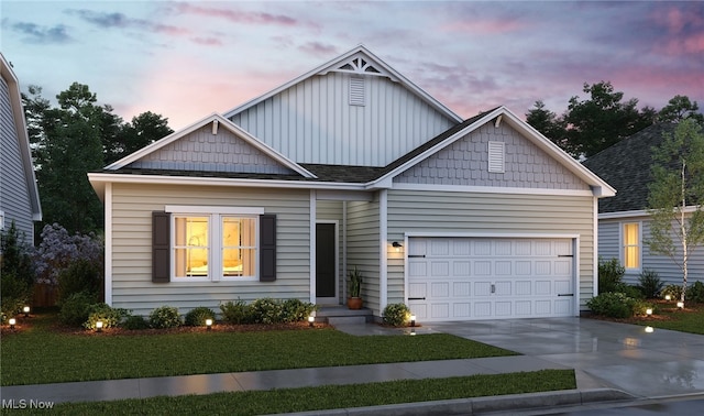 craftsman-style home featuring a garage and a yard