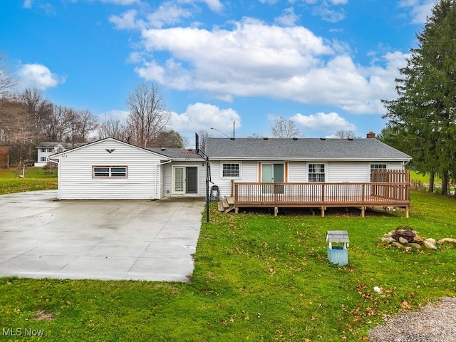 back of house with a lawn and a deck