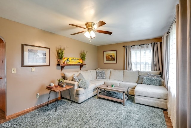 living room with ceiling fan and wood-type flooring