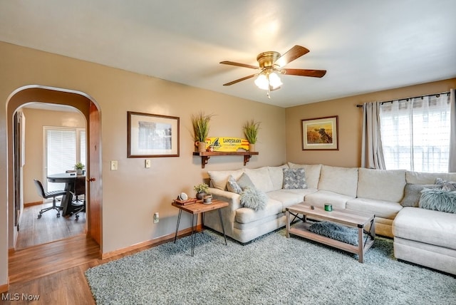 living room with hardwood / wood-style flooring and ceiling fan