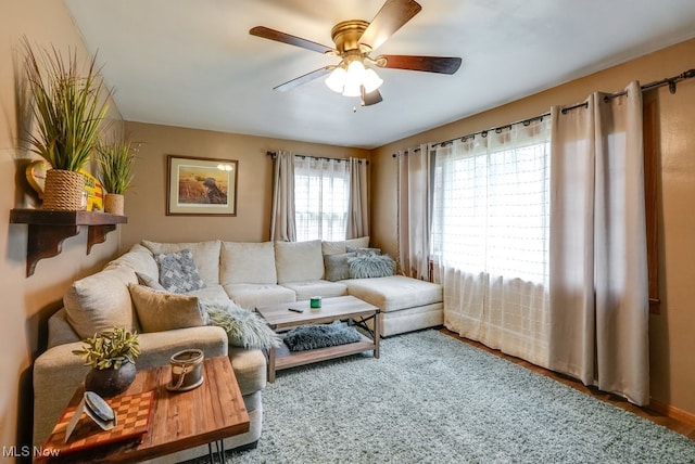 living room featuring hardwood / wood-style floors and ceiling fan