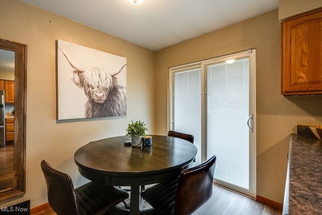 dining space featuring light wood-type flooring