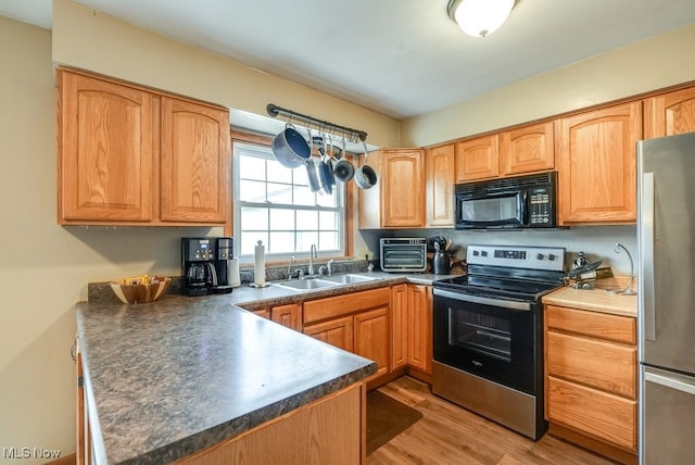 kitchen featuring light hardwood / wood-style floors, sink, and appliances with stainless steel finishes