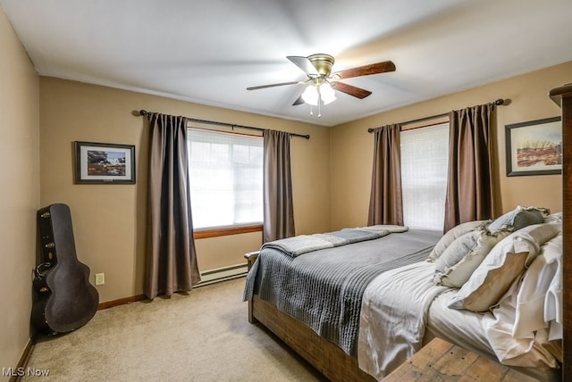 carpeted bedroom featuring ceiling fan and a baseboard radiator