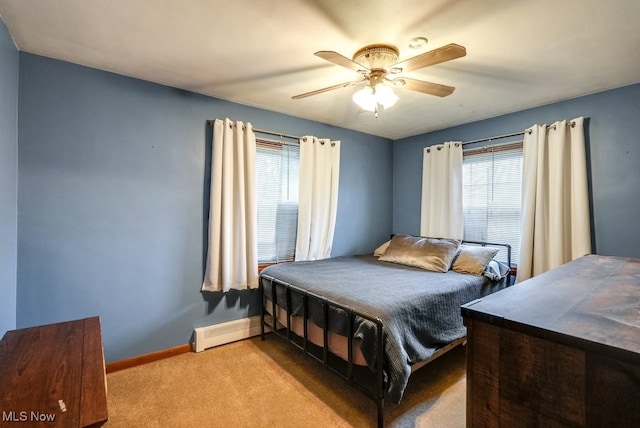 bedroom featuring light carpet, ceiling fan, and a baseboard heating unit