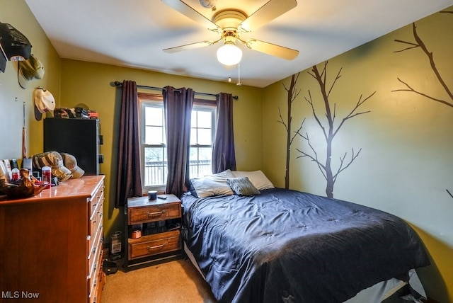 bedroom with ceiling fan and light carpet