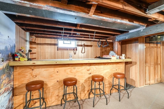 bar featuring wooden walls and carpet floors