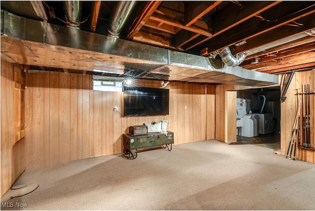 basement featuring carpet flooring, independent washer and dryer, and wooden walls