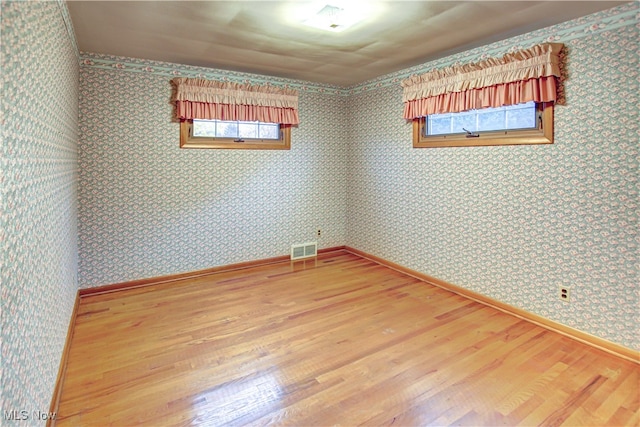 unfurnished room featuring wood-type flooring