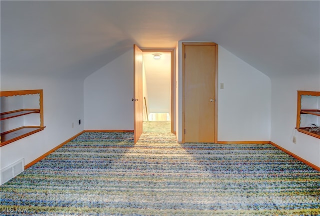 bonus room with carpet flooring and lofted ceiling