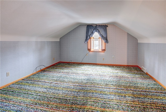 bonus room with carpet and lofted ceiling