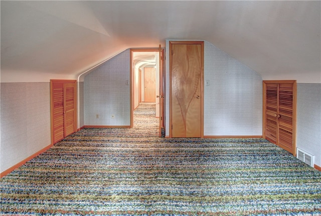 bonus room featuring carpet and vaulted ceiling