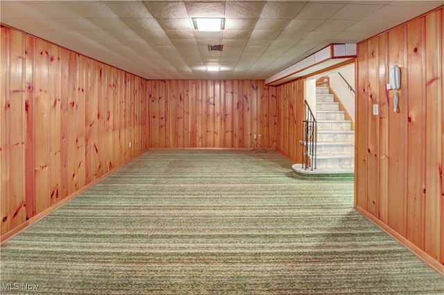 basement with wood walls and carpet floors