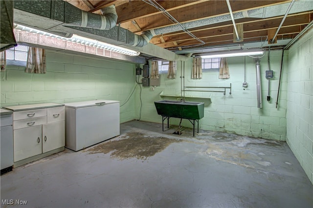 basement with sink and refrigerator