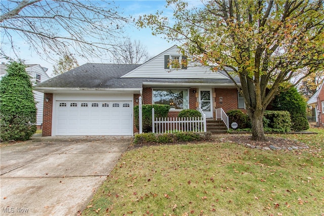 view of front of house featuring a front yard and a garage