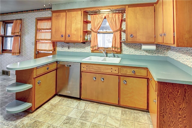 kitchen featuring kitchen peninsula, decorative backsplash, stainless steel dishwasher, and sink