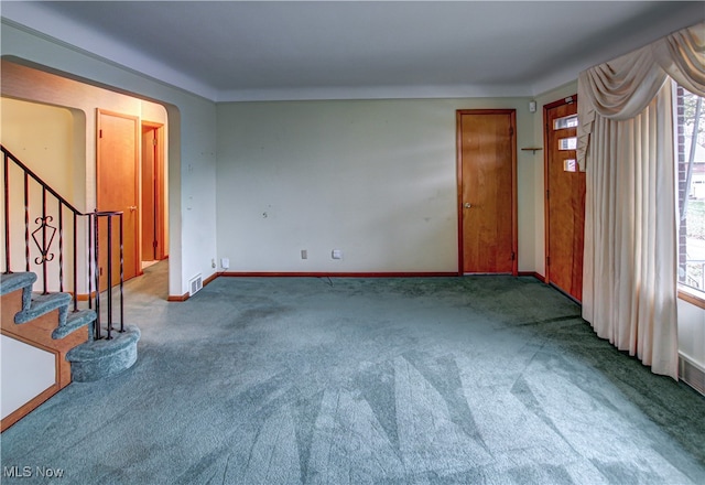 unfurnished living room featuring carpet and a healthy amount of sunlight