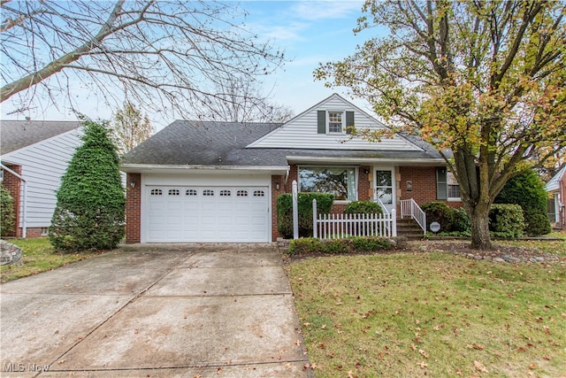 view of front of property featuring a front yard and a garage