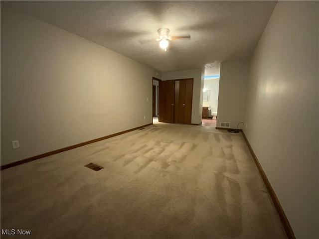 carpeted spare room with a textured ceiling