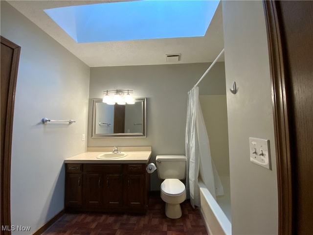 full bathroom featuring a skylight, shower / bath combo, parquet flooring, toilet, and vanity