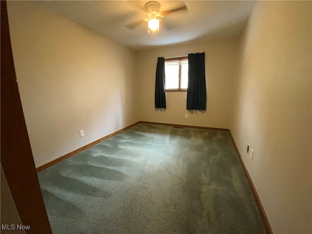 spare room featuring carpet flooring and ceiling fan