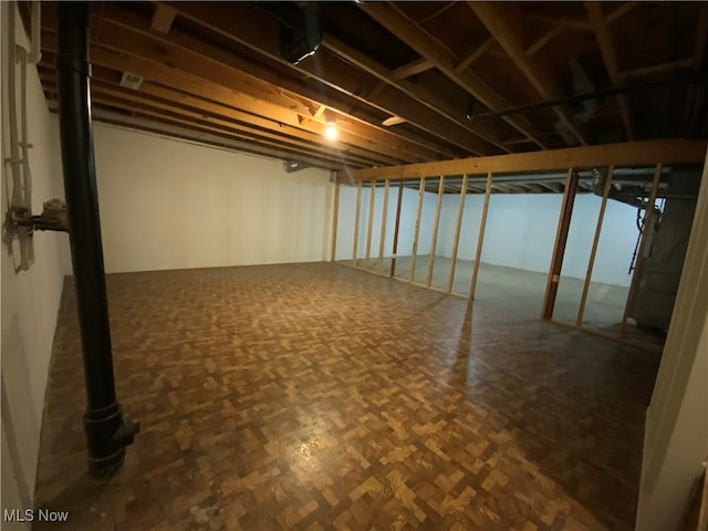 basement featuring dark parquet floors