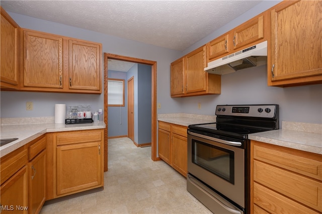 kitchen with a textured ceiling and stainless steel electric stove