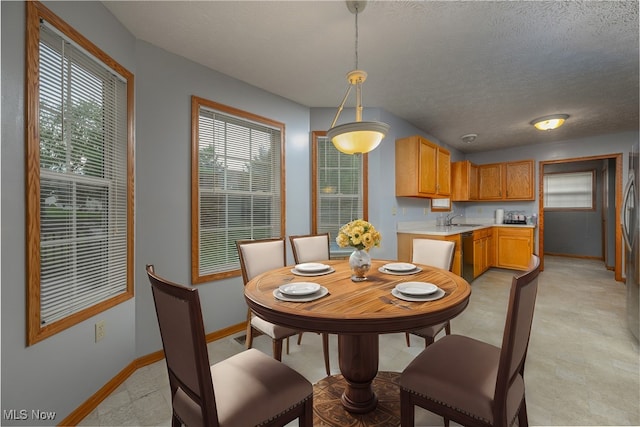 dining room featuring a textured ceiling and sink