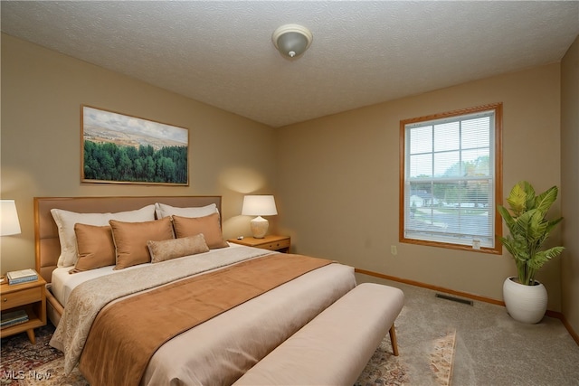 carpeted bedroom with a textured ceiling