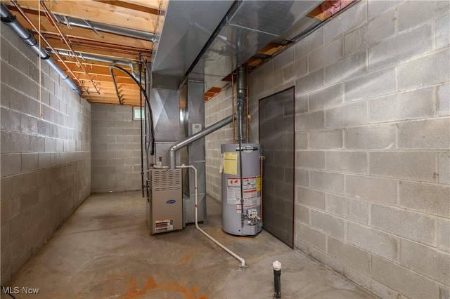 utility room featuring heating unit and water heater